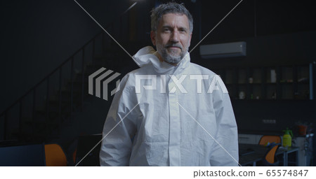 Decontamination personnel removing face mask 65574847