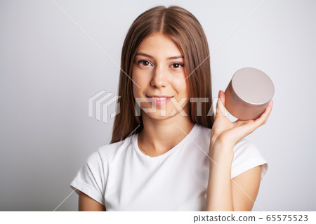 Woman Face Skin Cosmetics, pretty woman hold in hand facial cream 65575523