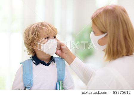 Mother and child with face mask and hand sanitizer 65575612