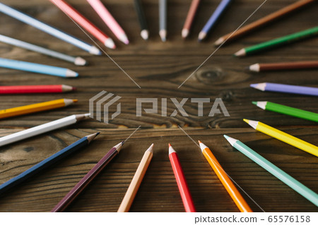Multicolored pencils lying on a table Multicolored pencils lying on a table 65576158