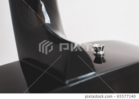 Close up of strap button of acoustic guitar. Close up of strap button of acoustic guitar. 65577140