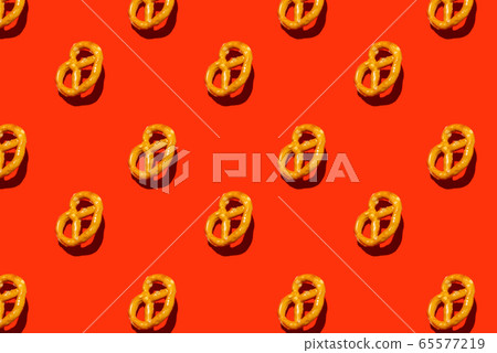 isometric flat lay with salty bagels on red background 65577219