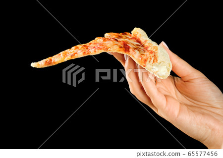 Hand holding slice of cheese pizza cut in slices 65577456