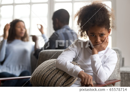 African kid daughter upset of parents fighting looking at camera African kid daughter upset of parents fighting looking at camera 65578714