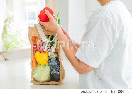 No face woman holding red bell paper from reusable 65580603