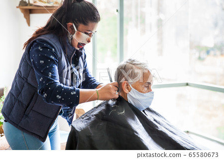 Senior woman getting a haircut at home during Covid-19 pandemic Senior woman getting a haircut at home during Covid-19 pandemic 65580673