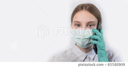 Close-up, teenage girl in medical mask wearing rubber gloves, makes phone call, listens to voice messages, talks her parents over mobile phone, stay home, virus disease protection pandemic covid 19 Close-up, teenage girl in medical mask wearing rubber gloves, makes phone call, listens to voice messages, talks her parents over mobile phone, stay home, virus disease protection pandemic covid 19 65580909