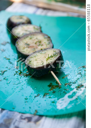 in a bowl, raw, struck eggplant in a marinade with herbs, dill in a rustic natural form. Preparation 65588118