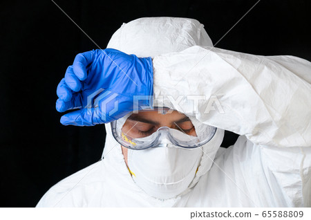 COVID-19. Exhausted Doctor, in personal protective equipment, worried as the coronavirus infected 65588809