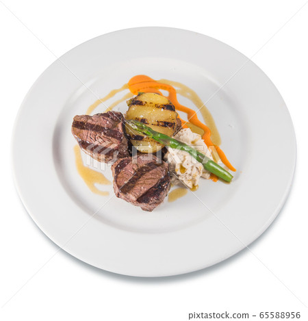Dish of grilled beef tenderloin medallions with baked potato and asparagus Dish of grilled beef tenderloin medallions with baked potato and asparagus 65588956