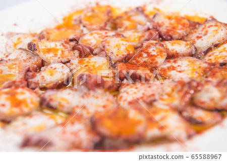 Typical Galician dish of fair style octopus with red pepper. Typical Galician dish of fair style octopus with red pepper. 65588967