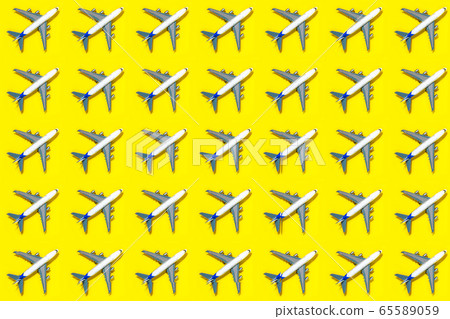 Pattern made of model airplane on yellow background. Pattern made of model airplane on yellow background. 65589059