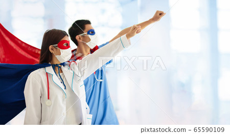 Doctor or nurse in face mask and superhero cape. 65590109