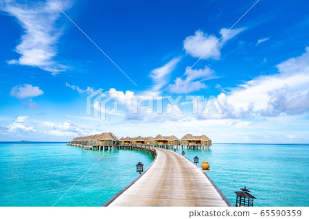 Continue to Maldives pier and clear skies over water cottage 65590359