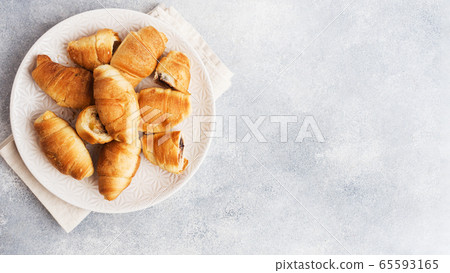 Croissants with chocolate filling on a plate gray background. Copy space. 65593165