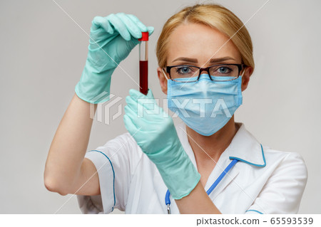 medical doctor nurse woman wearing protective mask and gloves - holding virus blood test tube 65593539