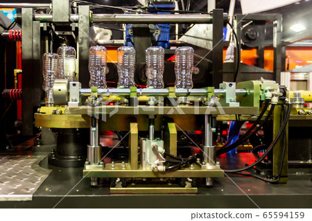 Plastic bottles ready to be filled on a bottling line of automatic PET/plastic bottle blow moulding machine. Plastic bottles ready to be filled on a bottling line of automatic PET/plastic bottle blow moulding machine. 65594159
