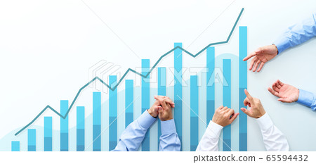 Business management meeting and blue graph. An overhead image of three men discussing at a white table. Business management meeting and blue graph. An overhead image of three men discussing at a white table. 65594432