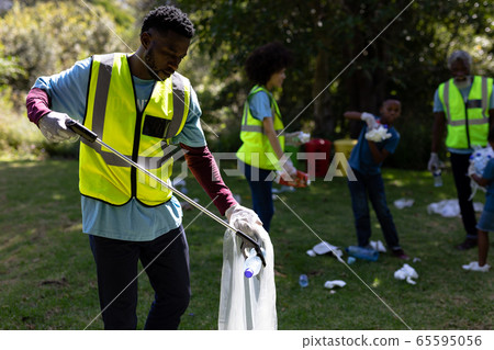 Multi-generation mixed race family collecting garbage 65595056