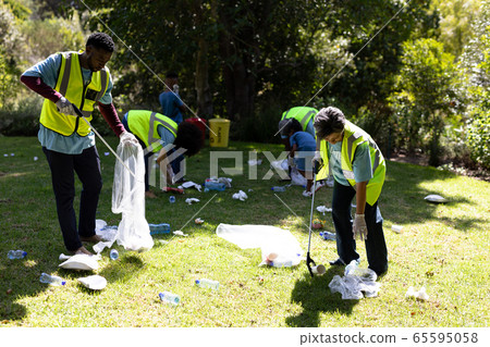 Multi-generation mixed race family collecting garbage Multi-generation mixed race family collecting garbage 65595058