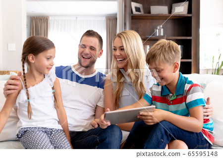 Caucasian family with two children using a tablet computer at home 65595148