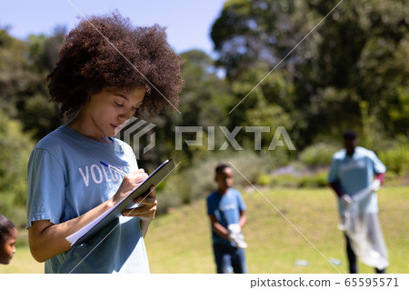 Volunteer mixed race woman enjoying her time outside 65595571
