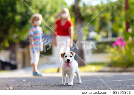 Family walking dog during virus outbreak Family walking dog during virus outbreak 65595598