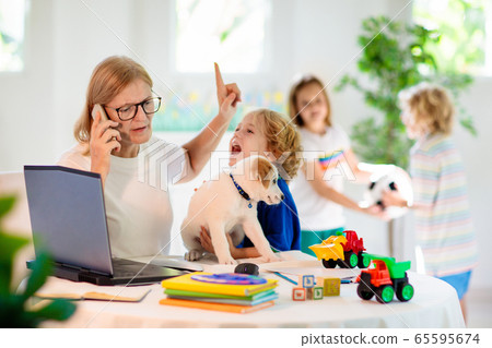 Mother working from home with kids. Quarantine. Mother working from home with kids. Quarantine. 65595674