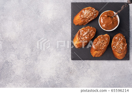 Sandwiches with baguette of bread spread with sweet paste of boiled condensed milk Copy space. Sandwiches with baguette of bread spread with sweet paste of boiled condensed milk Copy space. 65596214