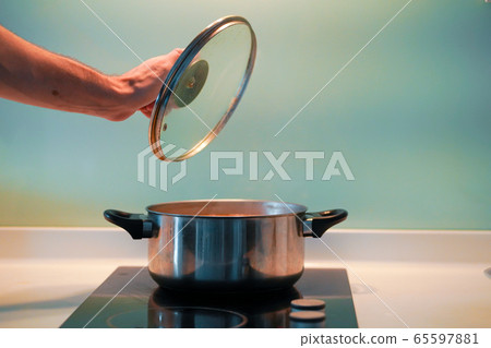 Cooking soup in a pan on an induction stove Cooking soup in a pan on an induction stove 65597881