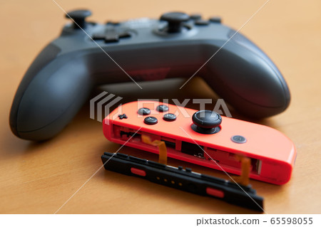 Broken game console controller and new controller 65598055