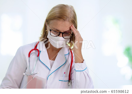 Exhausted tired doctor or nurse. Virus outbreak. 65598612