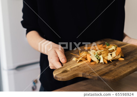 Millennial young woman recycling compost from kitchen waste. Circular economy, real food, organic 65598924