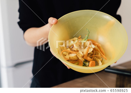 Millennial young woman recycling compost from kitchen waste. Circular economy, real food, organic 65598925