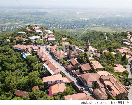 Aerial view to center Sighnaghi town and St George, Alazani valley in Georgia Aerial view to center Sighnaghi town and St George, Alazani valley in Georgia 65599399