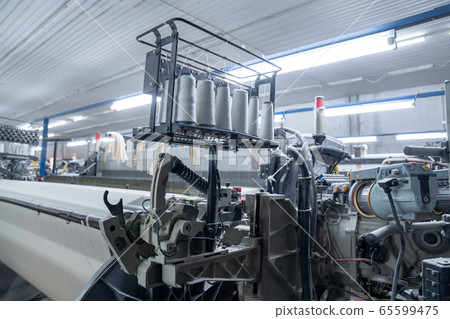 Interior of Textile factory with automated machinery.Concept of Industry and Technology. 65599475
