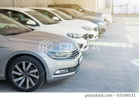 Cars in the parking lot on sunny day. Cars in the parking lot on sunny day. 65599531