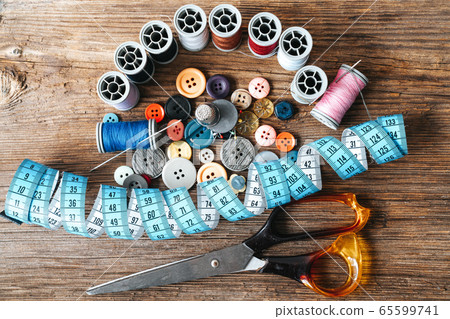 Group of objects about Sewing equipment set on a wooden background. Sewing and tailoring concept. Group of objects about Sewing equipment set on a wooden background. Sewing and tailoring concept. 65599741