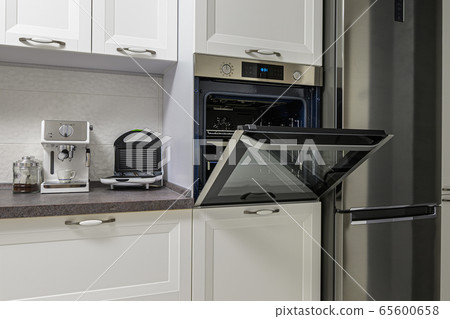 Electric appliances in minimalistic white kitchen interior Electric appliances in minimalistic white kitchen interior 65600658