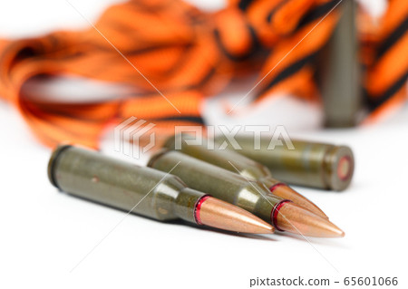 Cartridges lie on the background of the St. George ribbon. 65601066