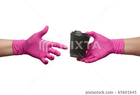hand in a pink latex glove holds a paper 65601645