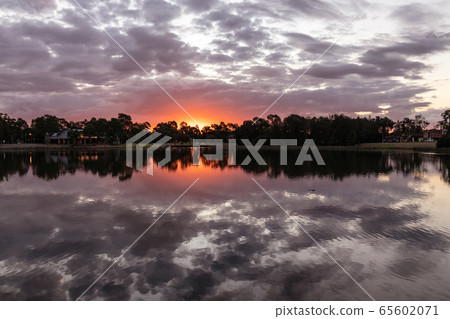 Beautiful sunset and clouds in the lake 65602071