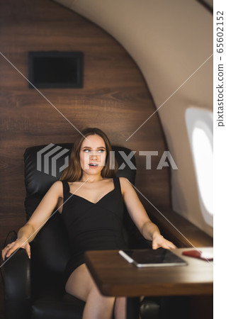 Attractive woman in private jet Attractive woman in private jet 65602152