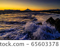 Mt. Fuji and waves splashed in orange at sunset 65603378