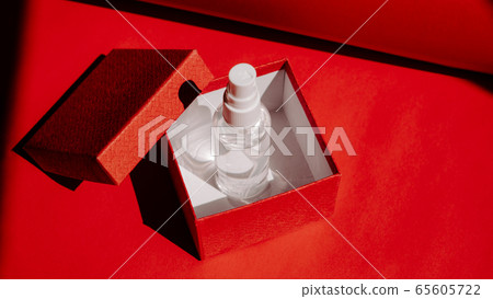 Post-Covid New Normal concept with Alcohol hand Sanitizing Spray as gift in red gift box. How Will Things Change In Post Pandemic World Post-Covid New Normal concept with Alcohol hand Sanitizing Spray as gift in red gift box. How Will Things Change In Post Pandemic World 65605722