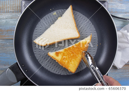 Chef baking parmesan cheese toast by pan Chef baking parmesan cheese toast by pan 65606370