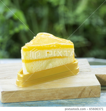 Orange cake on wood plate Orange cake on wood plate 65606371