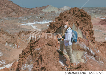 Backpacker in facial mask, tourist season 2020. Backpacker in facial mask, tourist season 2020. 65606726