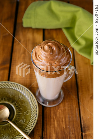 A long glass of delicious whipped Dalgona Coffee A long glass of delicious whipped Dalgona Coffee 65607163
