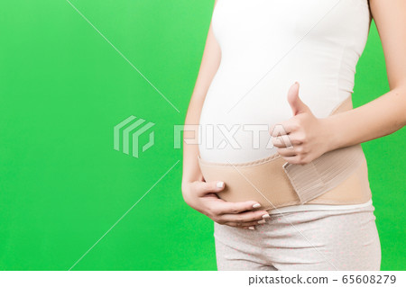 Close up of pregnant woman showing thumb up and Close up of pregnant woman showing thumb up and 65608279